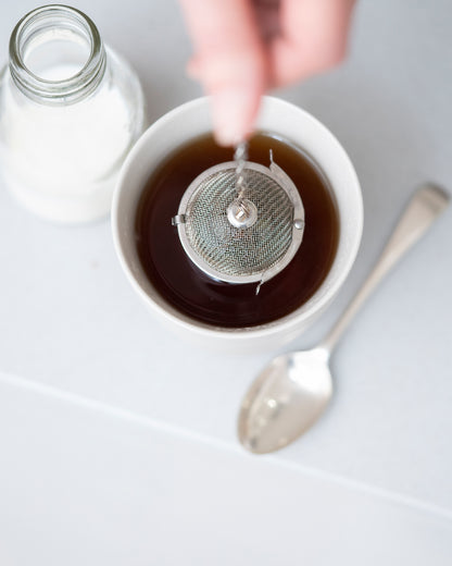 Small metal tea basket on a metal cord