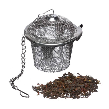 Small metal tea basket with a metal cord and loose tea leaves
